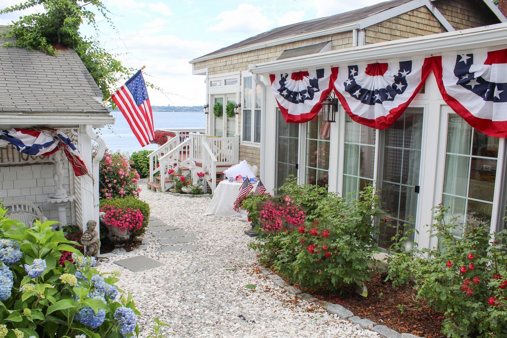 Old fashioned designer front porch living by the sea with expansive water views.